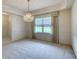 Spacious dining room with neutral carpet, bright window, and elegant chandelier at 3985 Cree Dr, Ormond Beach, FL 32174