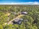 Overhead shot of the property showing the house, workshop, shed, chicken coop and wooded area at 4252 Quail Ranch Rd, New Smyrna Beach, FL 32168