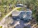 Aerial view of a home featuring an expansive yard, outbuildings, and a serene setting at 4252 Quail Ranch Rd, New Smyrna Beach, FL 32168