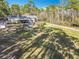 Overhead view of the home, with a view of the yard, fire pit, chicken coop and shed at 4252 Quail Ranch Rd, New Smyrna Beach, FL 32168