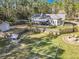 Aerial view of a backyard with a fence, fire pit, shed, play area, and patio at 4252 Quail Ranch Rd, New Smyrna Beach, FL 32168