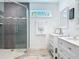 Bathroom showcasing a glass-enclosed shower, double sink vanity, and framed mirror at 4252 Quail Ranch Rd, New Smyrna Beach, FL 32168