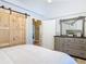Bedroom with a large dresser, barn door, and accents providing a cozy retreat at 4252 Quail Ranch Rd, New Smyrna Beach, FL 32168