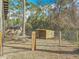 Exterior shot of a wood chicken coop and an outdoor fence in a wooded and grassy backyard at 4252 Quail Ranch Rd, New Smyrna Beach, FL 32168
