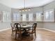 Light-filled dining room featuring a wooden table, stylish chairs, and a modern light fixture at 4252 Quail Ranch Rd, New Smyrna Beach, FL 32168