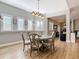 Dining area featuring a round table, wood floors, lots of windows with natural light, and views into the living area at 4252 Quail Ranch Rd, New Smyrna Beach, FL 32168