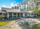 Charming single-story home with a covered front porch, rocking chairs and a large gravel driveway at 4252 Quail Ranch Rd, New Smyrna Beach, FL 32168