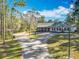 Exterior of home with long driveway surrounded by lush greenery at 4252 Quail Ranch Rd, New Smyrna Beach, FL 32168