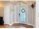 Bright foyer with beautiful flooring and front door featuring glass panes and a wreath at 4252 Quail Ranch Rd, New Smyrna Beach, FL 32168