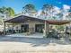 Spacious metal garage featuring a covered area, ample storage, and workspace at 4252 Quail Ranch Rd, New Smyrna Beach, FL 32168