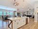 Bright kitchen with a large island featuring white countertops, stainless steel appliances, and an open view to the living room at 4252 Quail Ranch Rd, New Smyrna Beach, FL 32168
