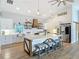 Bright, open kitchen with a large island, wooden accents, stainless steel appliances, and stylish decor at 4252 Quail Ranch Rd, New Smyrna Beach, FL 32168