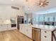 Open kitchen with a large island, stainless steel appliances, white cabinets, and modern decor at 4252 Quail Ranch Rd, New Smyrna Beach, FL 32168