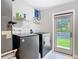 Well-equipped laundry area with modern appliances and convenient access to the outdoors at 4252 Quail Ranch Rd, New Smyrna Beach, FL 32168