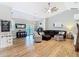Spacious living room with modern decor, wood floors, a leather sectional, and lots of natural light at 4252 Quail Ranch Rd, New Smyrna Beach, FL 32168