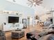 Open-concept living area showcasing wood floors, modern furniture, and a seamless transition to the kitchen at 4252 Quail Ranch Rd, New Smyrna Beach, FL 32168