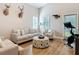 Comfortable living room with natural light, neutral furnishings, and exercise equipment at 4252 Quail Ranch Rd, New Smyrna Beach, FL 32168