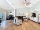 Bright living room featuring high ceilings, wood floors, a large sofa, and a view of the office area at 4252 Quail Ranch Rd, New Smyrna Beach, FL 32168