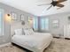 Cozy main bedroom featuring neutral walls, wood-look flooring, and light-filled windows at 4252 Quail Ranch Rd, New Smyrna Beach, FL 32168