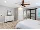 Spacious main bedroom with a ceiling fan, wood-look flooring, and ensuite bathroom access at 4252 Quail Ranch Rd, New Smyrna Beach, FL 32168