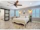 The main bedroom features shuttered windows and a sliding barn door to the ensuite bathroom at 4252 Quail Ranch Rd, New Smyrna Beach, FL 32168