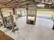 Elevated view of metal building interior featuring an ATV, lift, and a garage door at 4252 Quail Ranch Rd, New Smyrna Beach, FL 32168