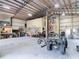 Spacious metal building interior featuring a lift, storage shelving, and recreational equipment for various activities at 4252 Quail Ranch Rd, New Smyrna Beach, FL 32168