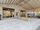 Vast metal building interior offering versatile space with picnic tables, shelving, and ample storage at 4252 Quail Ranch Rd, New Smyrna Beach, FL 32168