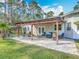 Inviting outdoor patio space with a pergola, comfortable seating, and a fire pit, great for entertaining at 4252 Quail Ranch Rd, New Smyrna Beach, FL 32168