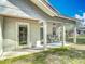 Charming covered patio with seating area, ideal for relaxing and enjoying outdoor views at 4252 Quail Ranch Rd, New Smyrna Beach, FL 32168