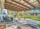 Covered patio with comfortable seating, a fire pit, and views of the expansive backyard at 4252 Quail Ranch Rd, New Smyrna Beach, FL 32168