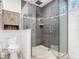 Shower with gray tiling, glass enclosure, and overhead rain shower head at 4252 Quail Ranch Rd, New Smyrna Beach, FL 32168
