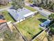 Expansive backyard featuring a well-maintained lawn, perimeter fence and a covered area extending from the main home at 509 Kettering Rd, Deltona, FL 32725