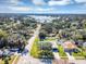 Aerial view of neighborhood with mature trees and a scenic lake in the background at 509 Kettering Rd, Deltona, FL 32725
