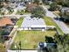 Spacious fenced backyard featuring a large grassy area, mature trees and a covered patio perfect for entertaining at 509 Kettering Rd, Deltona, FL 32725