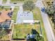 Aerial view of the backyard featuring a patio, lush lawn, and surrounding residential area at 509 Kettering Rd, Deltona, FL 32725