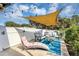 A backyard features a large patio with outdoor seating and a sun shade at 509 Kettering Rd, Deltona, FL 32725