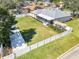 Aerial view of expansive backyard featuring a white fence, patio, and lush lawn at 509 Kettering Rd, Deltona, FL 32725