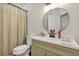 This bathroom features a vanity with a circular mirror, a toilet, and a shower at 509 Kettering Rd, Deltona, FL 32725