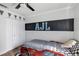 Fun bedroom featuring a racecar bed, ceiling fan and checkered flag decor at 509 Kettering Rd, Deltona, FL 32725