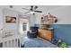 Charming bedroom featuring baseball-themed decor and a comfortable armchair at 509 Kettering Rd, Deltona, FL 32725
