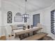 Dining room with modern chandelier, decorative wall hangings, and luxury vinyl plank flooring at 509 Kettering Rd, Deltona, FL 32725