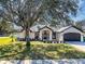 Charming single-story home with a landscaped front yard and attached two-car garage at 509 Kettering Rd, Deltona, FL 32725