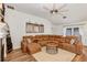 Spacious living room featuring a large sectional sofa, modern ceiling fan, and luxury vinyl plank flooring at 509 Kettering Rd, Deltona, FL 32725