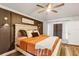 This main bedroom features a wooden bed frame, neutral walls, and a fan at 509 Kettering Rd, Deltona, FL 32725