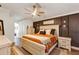 This main bedroom features a wooden bed frame, wood-look floors, and neutral walls at 509 Kettering Rd, Deltona, FL 32725