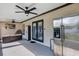 Outdoor patio with ceiling fans, seating and an outdoor refrigerator at 509 Kettering Rd, Deltona, FL 32725