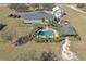 Expansive property featuring a house, pool, barn, lush landscaping, and multiple outbuildings at 5306 Empire Church Rd, Groveland, FL 34736