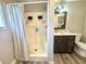 This bathroom includes a shower and vanity with modern fixtures and neutral tones at 5306 Empire Church Rd, Groveland, FL 34736