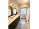 Well-lit bathroom with double sink vanity, framed mirrors, and updated fixtures at 5306 Empire Church Rd, Groveland, FL 34736